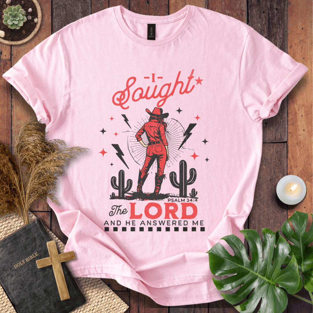 Cowgirl in red standing in a desert with cacti and lightning, text reads I Sought The Lord And He Answered Me Psalm 34:4.