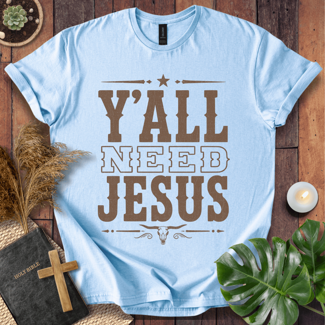 Y'all Need Jesus country western graphic tee with a longhorn skull design next to a Bible and cross.