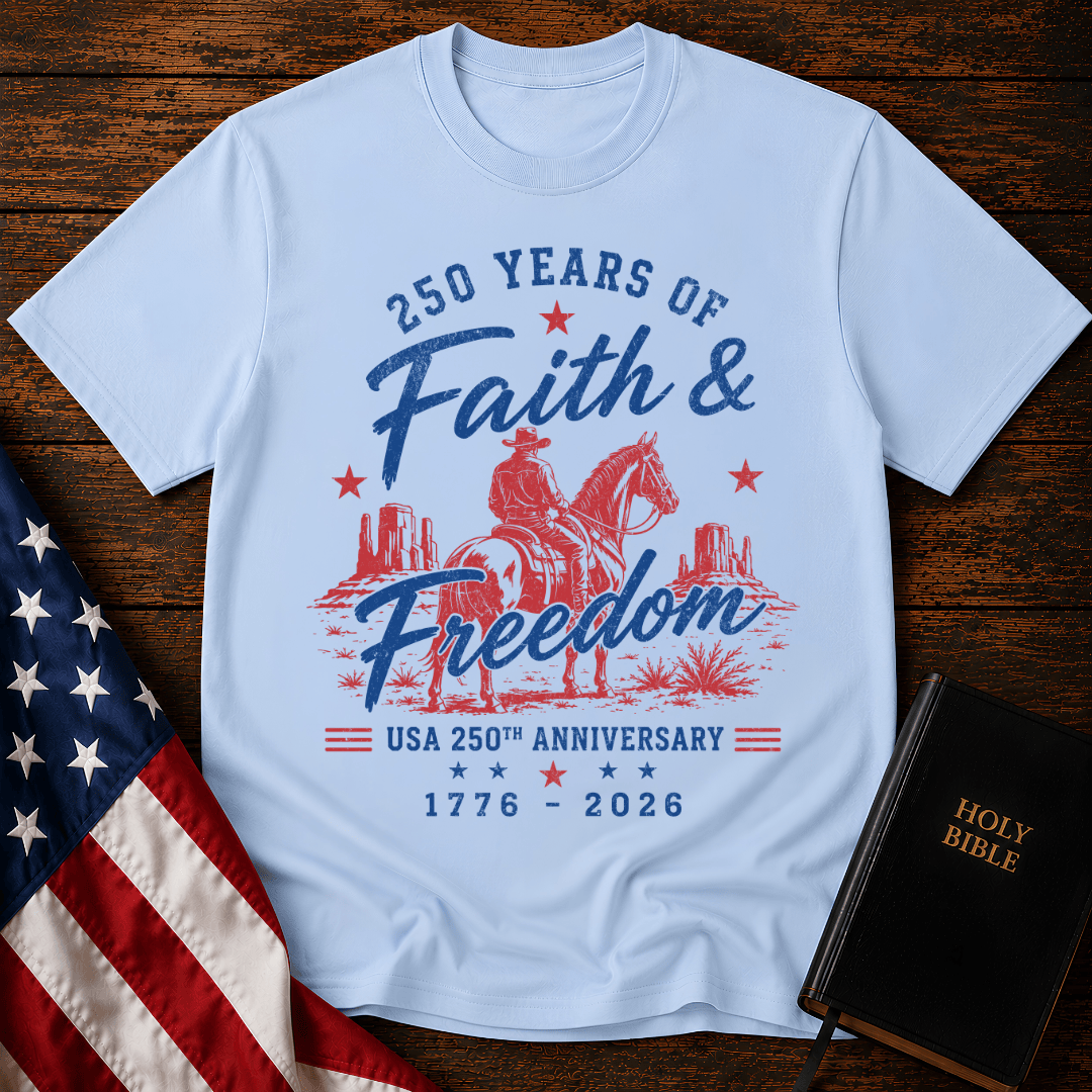 Christian t shirt for women featuring a cowboy on a horse looking at canyon mesas with Faith & Freedom text.