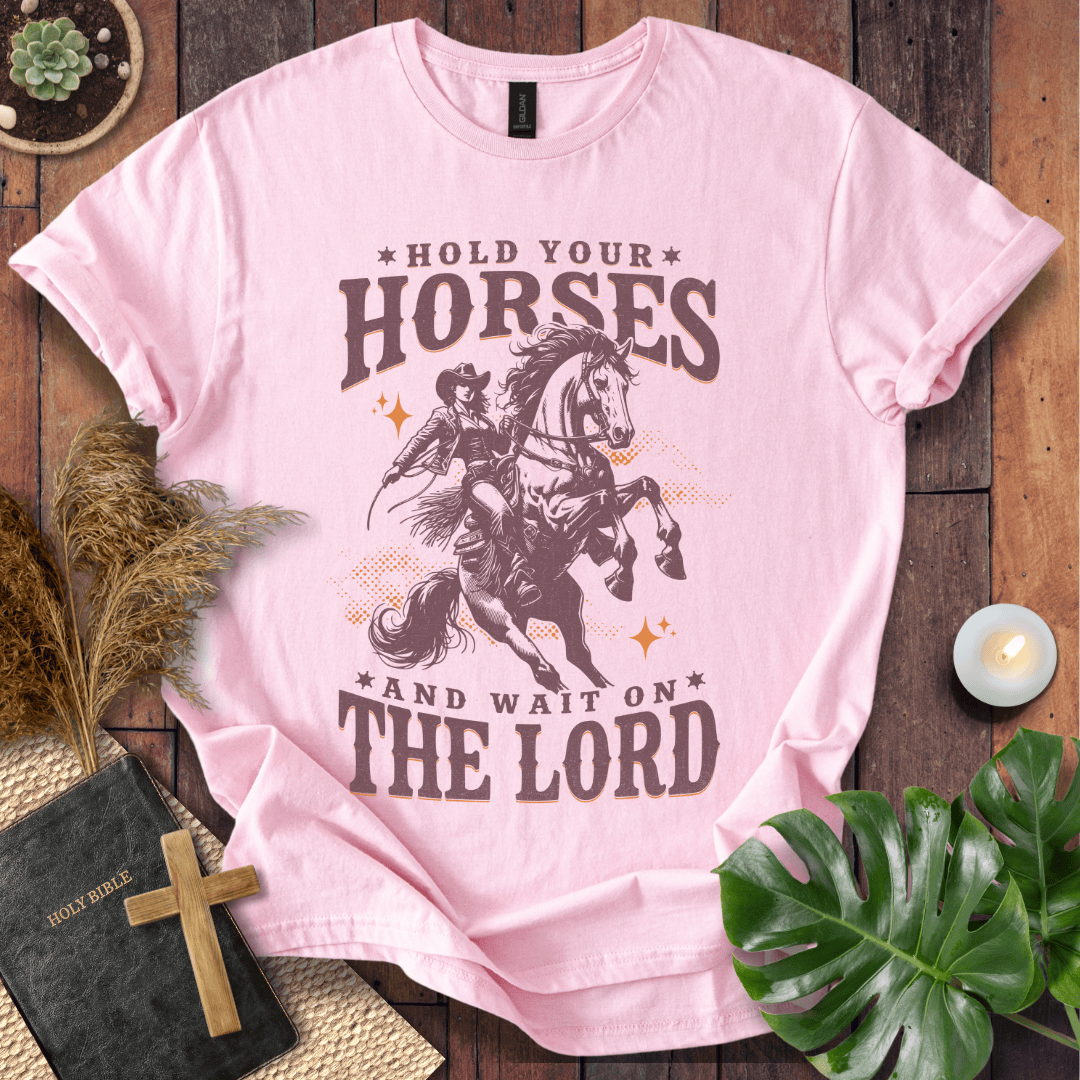 Cowgirl riding a rearing horse on a t-shirt with text saying Hold Your Horses and Wait on the Lord.