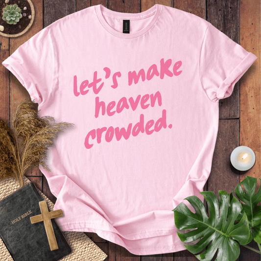 A light pink short-sleeve T-shirt with the phrase 'let's make heaven crowded.' printed in pink script across the front.