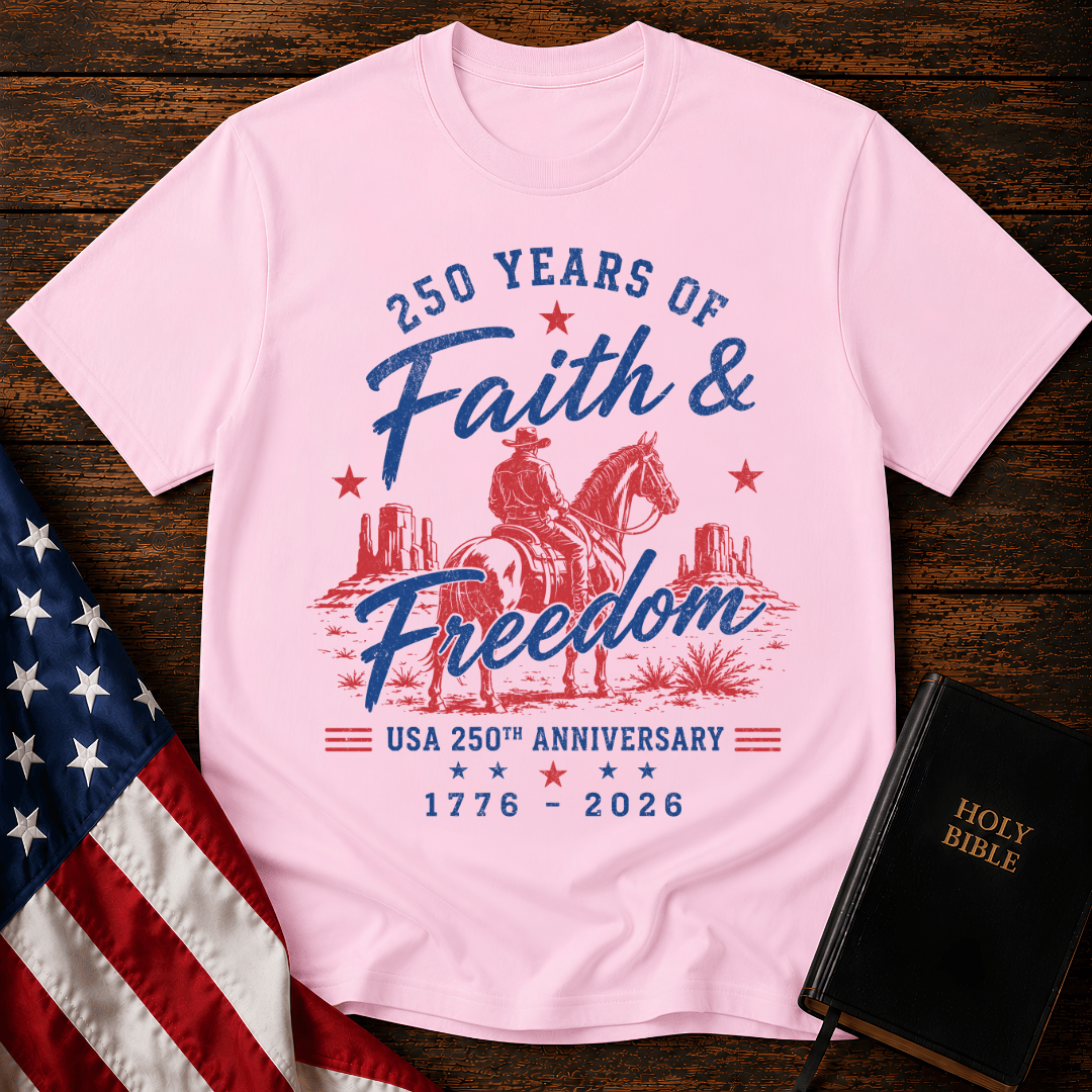 Christian t shirt for women featuring a cowboy on a horse looking at canyon mesas with Faith & Freedom text.