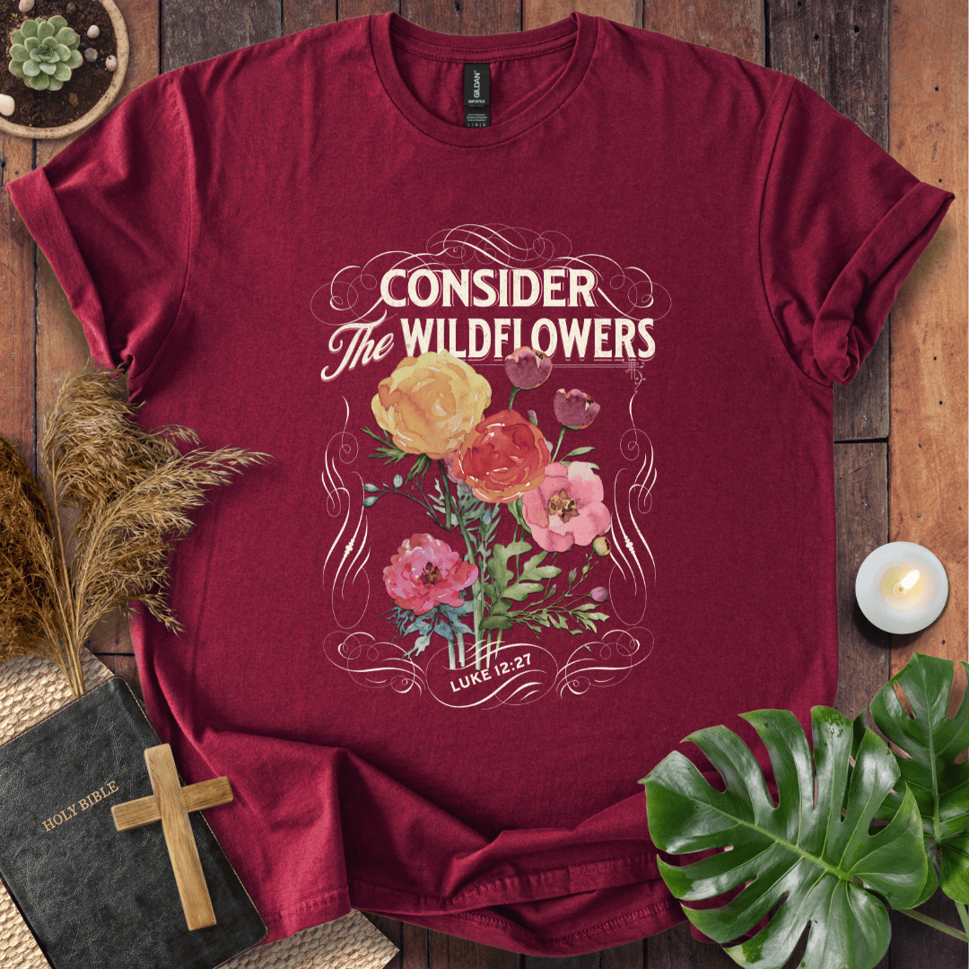 Christian t-shirt with watercolor wildflowers and Luke 12:27 scripture "Consider the Wildflowers" in a vintage scroll frame.