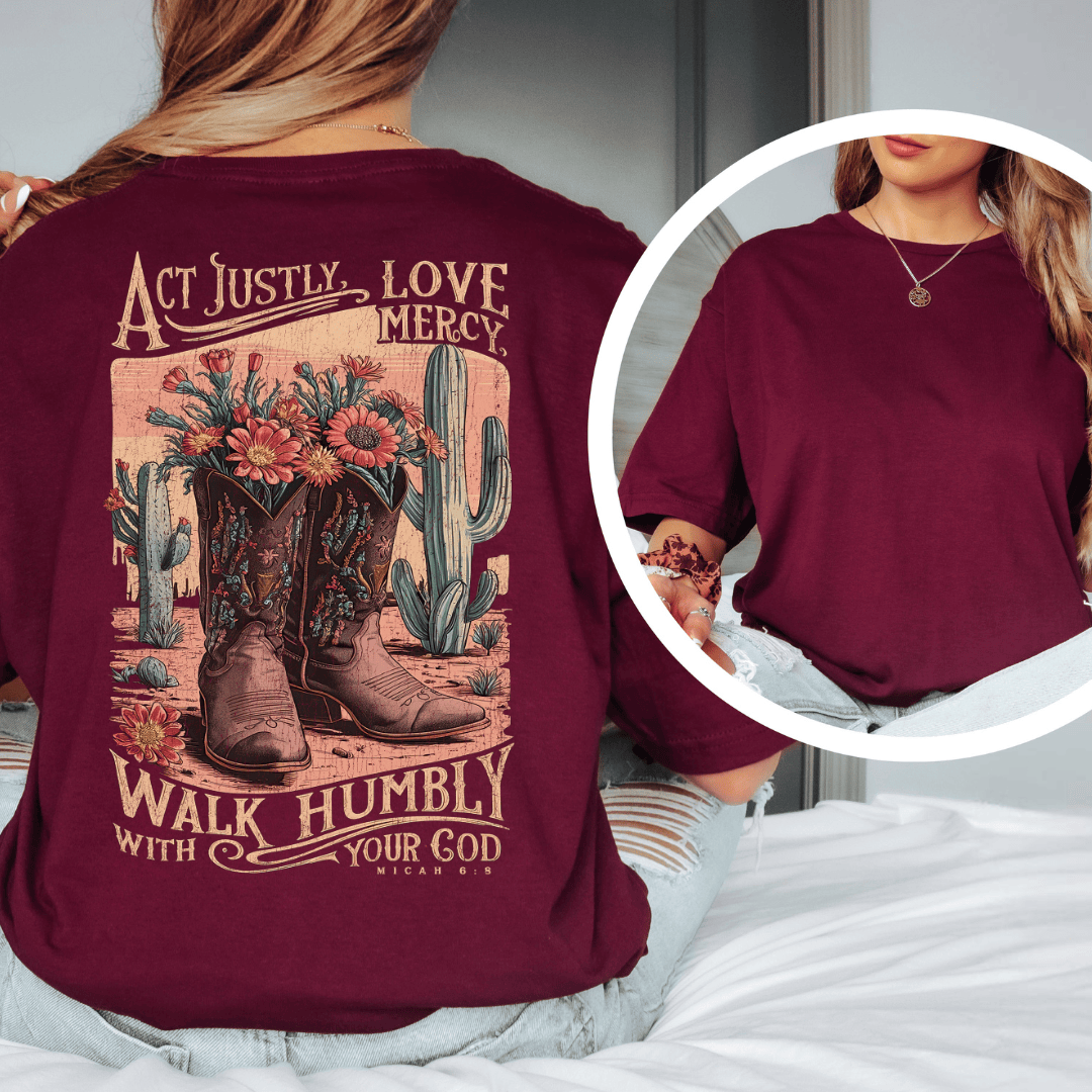 Rear view of a woman wearing Micah 6:8 t-shirt from Black.jpg, featuring western cowboy boots, cacti, and desert wildflowers.