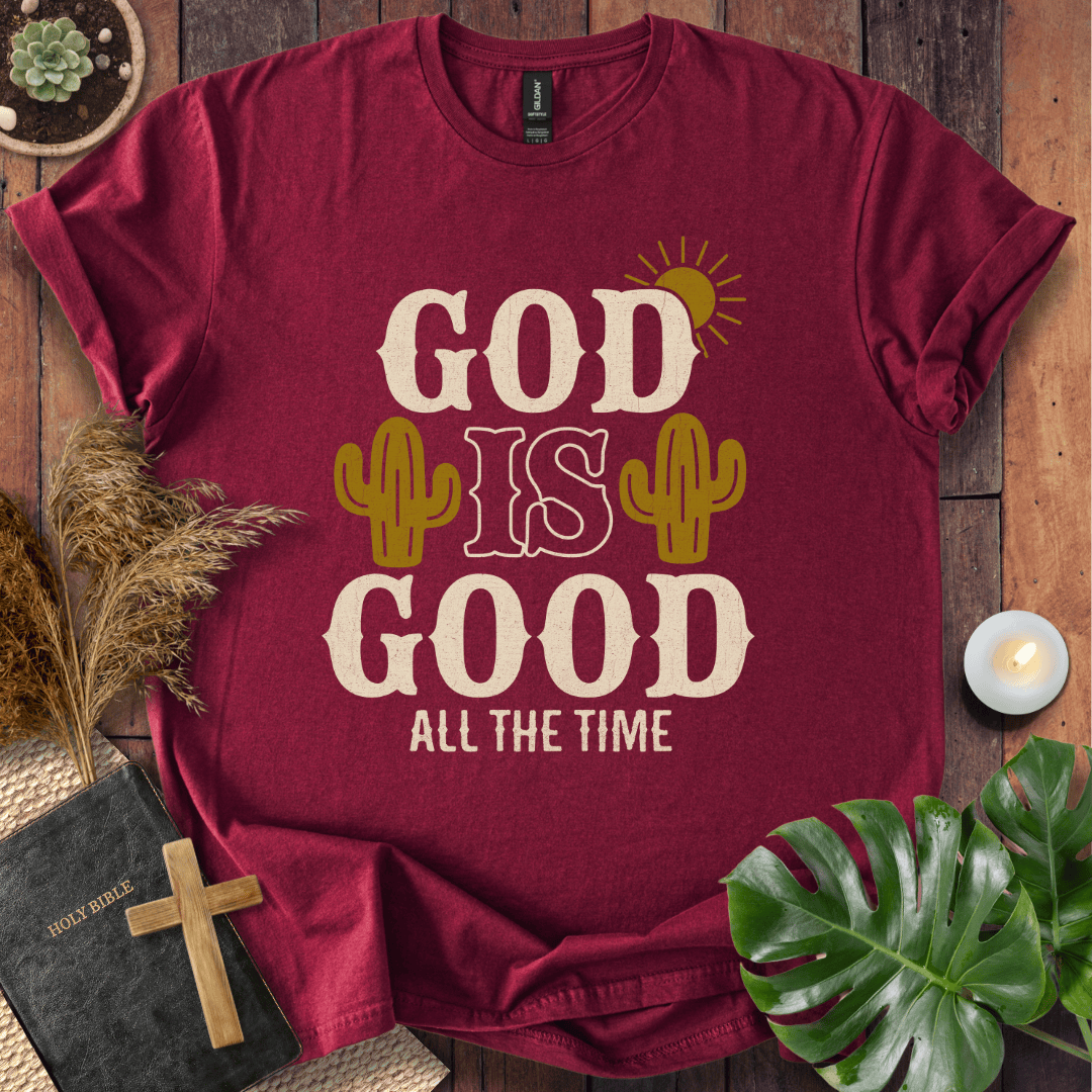 God Is Good All The Time t-shirt with cacti and sun graphics, styled with a Bible and wooden cross.
