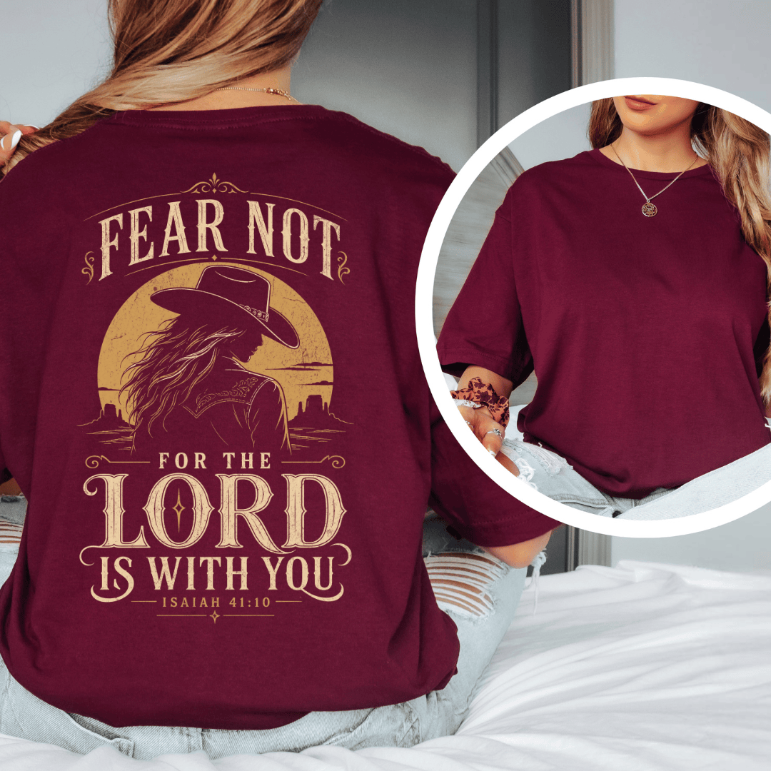 t-shirt showing a cowgirl silhouette in front of a desert sun with the words Fear Not Isaiah 41:10.
