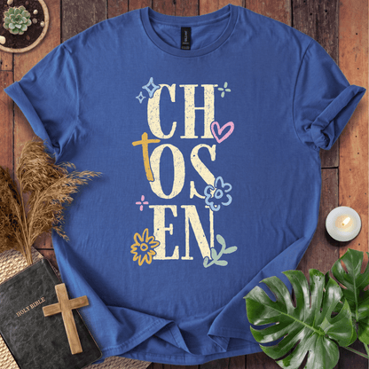 Distressed "CHOSEN" graphic on a t-shirt with a rustic gold cross and colorful boho wildflowers.
