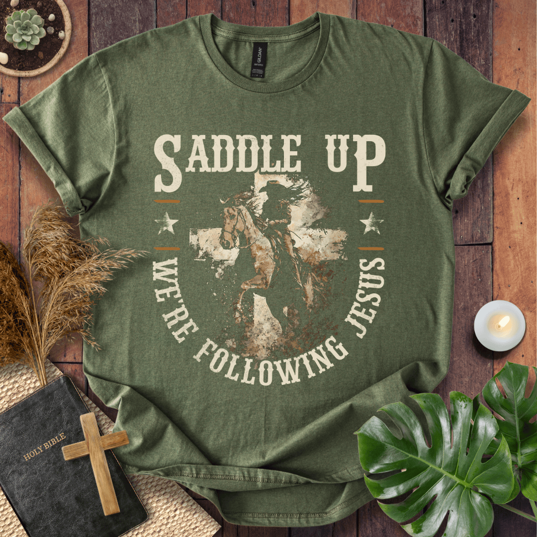 t-shirt featuring a horse and rider silhouette on a cross with text Saddle Up We're Following Jesus in a vintage style.