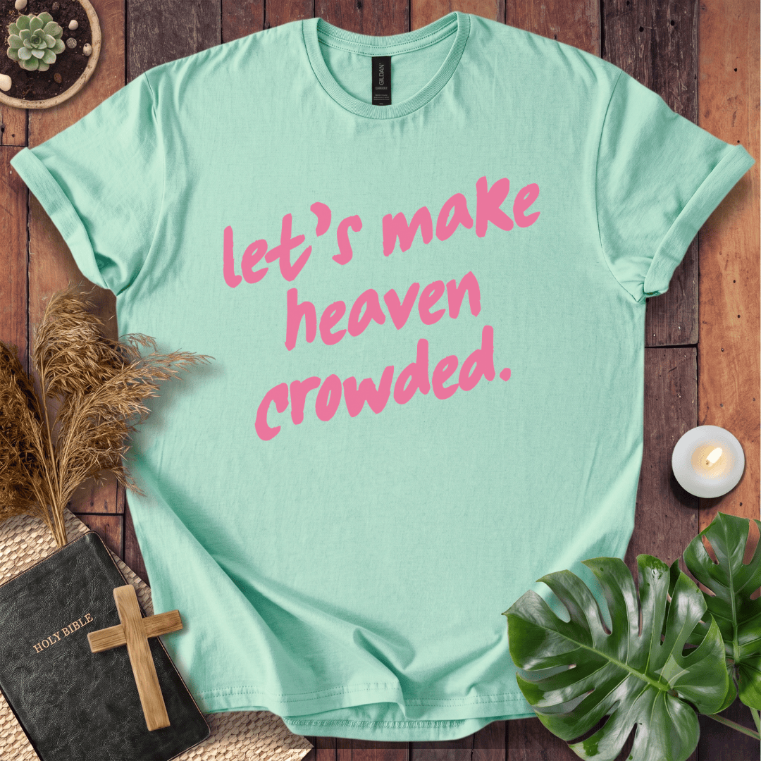 A mint green short-sleeve t-shirt with the phrase 'let's make heaven crowded.' printed in pink script across the front.