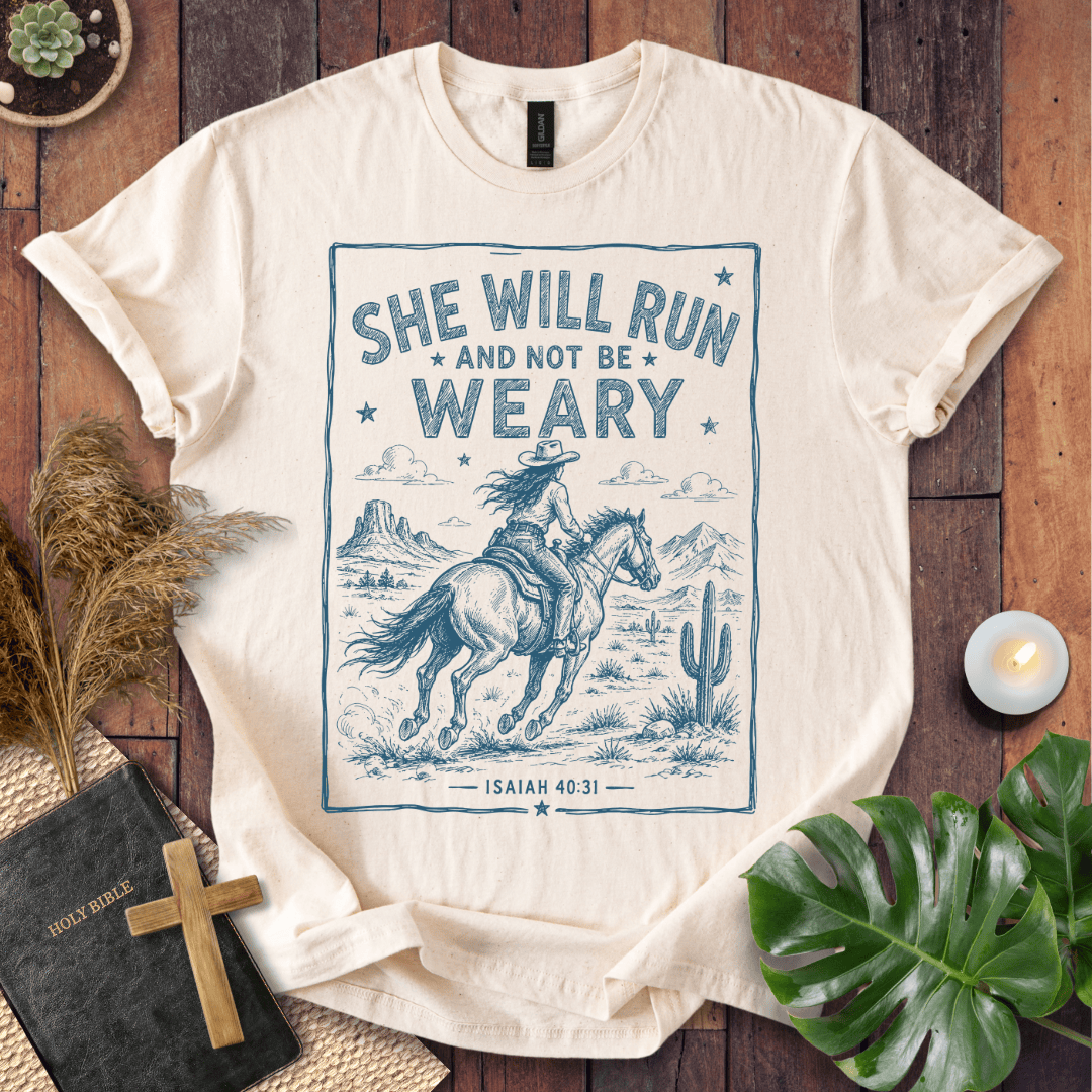 graphic tee with a blue sketch of a cowgirl riding a horse in the desert under Isaiah forty thirty-one text.