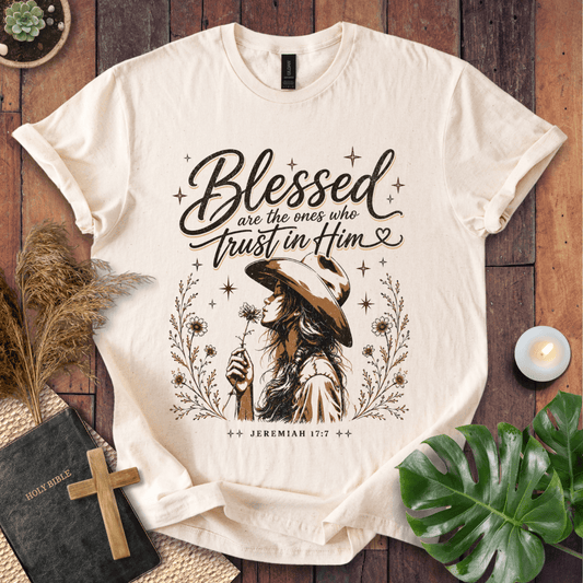 Jeremiah 17:7 sand t-shirt featuring a western woman in a cowboy hat holding a flower with stars and branches.