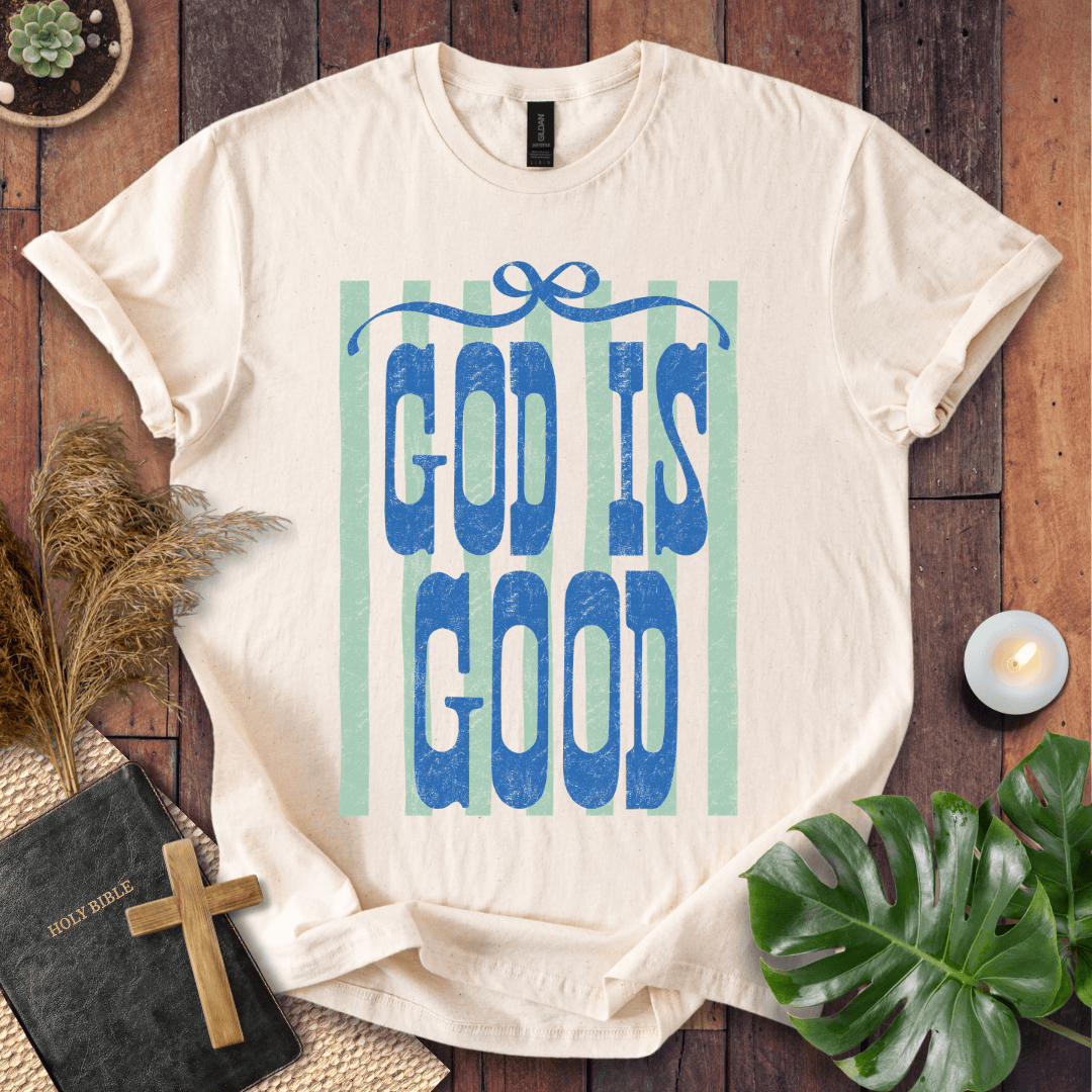God Is Good graphic printed on a white t-shirt featuring a retro blue bow and vintage sage green vertical stripes.