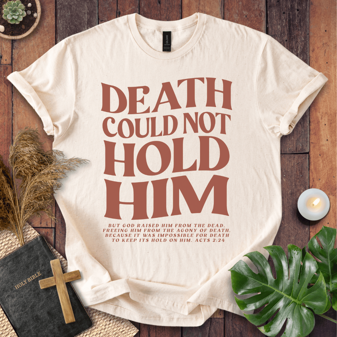 Christian Easter t-shirt with "Death Could Not Hold Him" Acts 2:24 text, styled with a Bible and wooden cross
