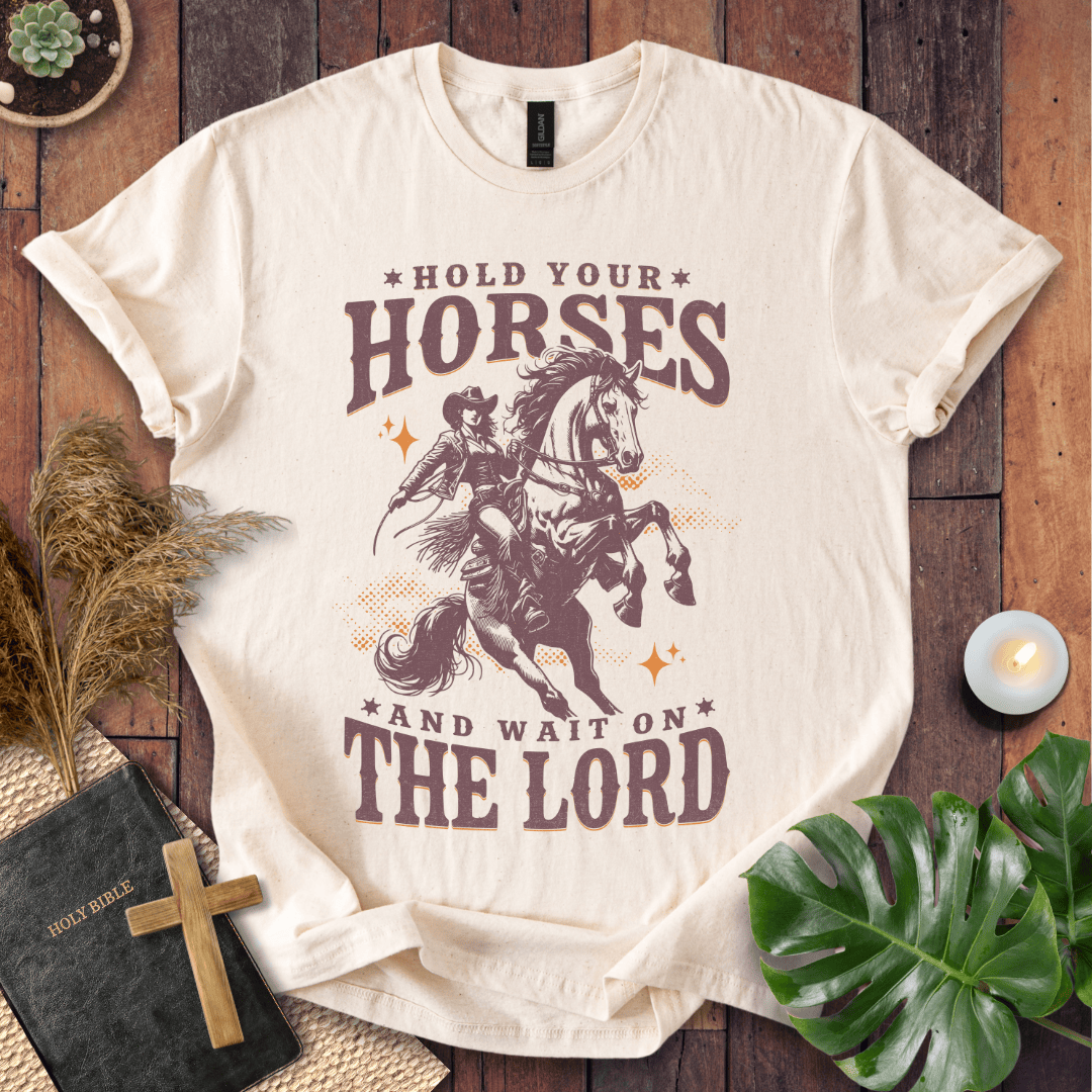 Cowgirl riding a rearing horse on a t-shirt with text saying Hold Your Horses and Wait on the Lord.