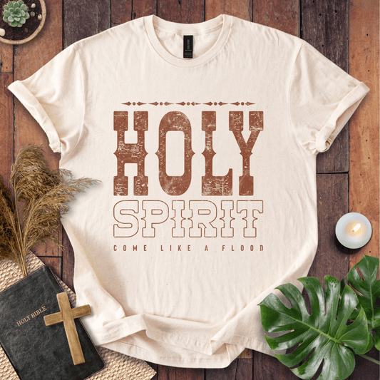 Christian t-shirt with "Holy Spirit Come Like A Flood" in distressed brown western font on a rustic wood background.