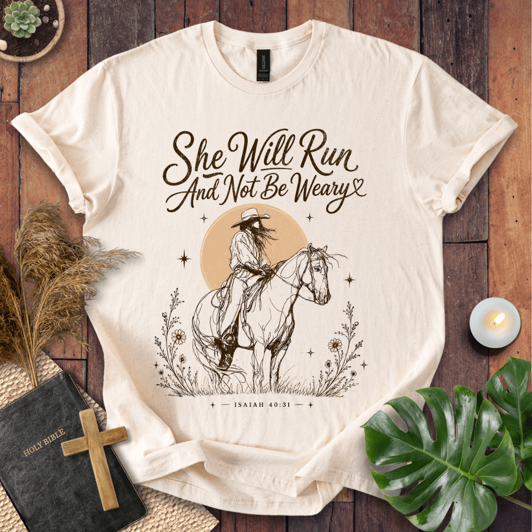 A vintage cream t-shirt featuring a sketched cowgirl on a horse under a desert sun with Isaiah 40:31.