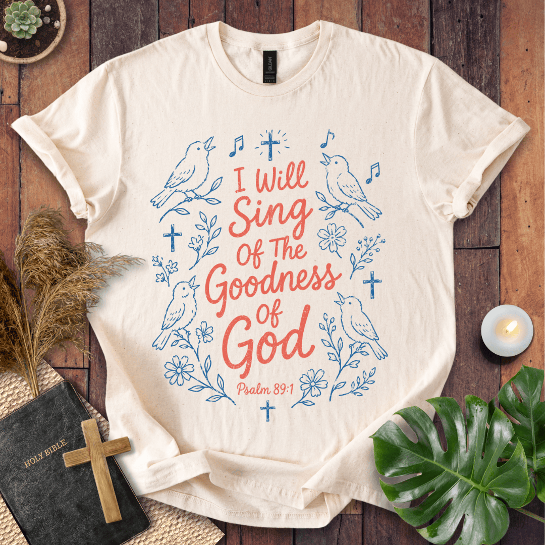 Beige t-shirt with bull skull design and text on a wooden surface with decor items.
