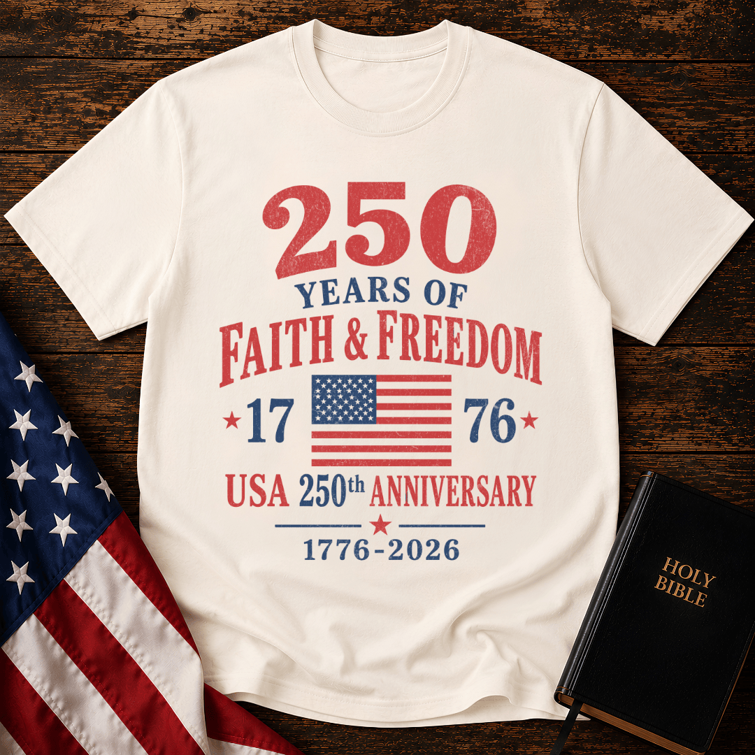 Patriotic t-shirt reading 250 Years of Faith and Freedom 1776 to 2026 with an American flag on a wood 
