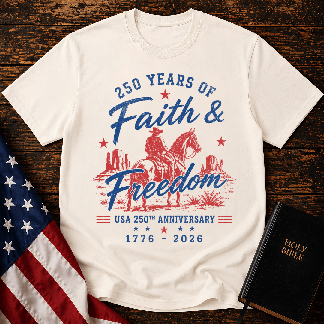 Christian t shirt for women featuring a cowboy on a horse looking at canyon mesas with Faith & Freedom text.