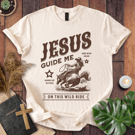 Vintage style t-shirt with a cowgirl riding a horse and text reading Jesus Guide Me On This Wild Ride.