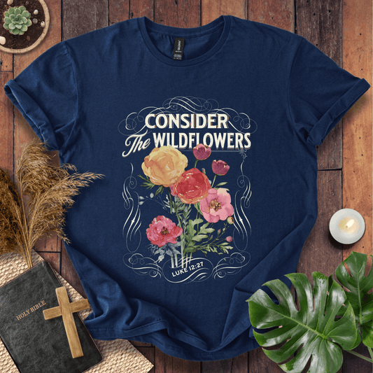 Christian t-shirt with watercolor wildflowers and Luke 12:27 scripture "Consider the Wildflowers" in a vintage scroll frame.
