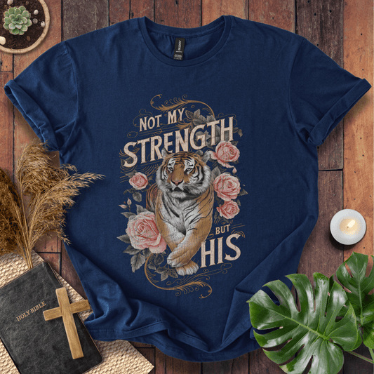 Not My Strength But His Christian t-shirt in black—tiger with roses and vintage script faith design.