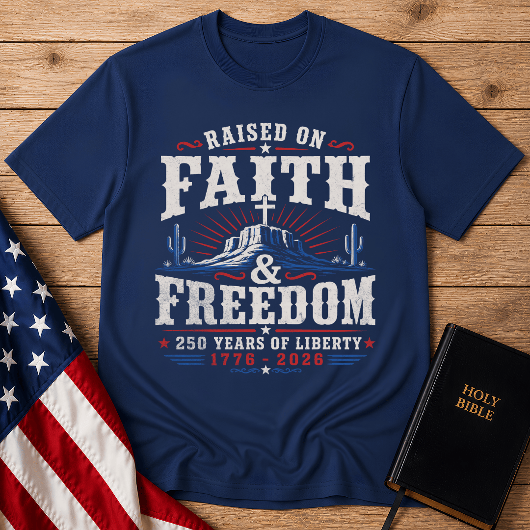 graphic t shirt featuring a cross on a desert mesa with the text Raised on Faith and Freedom 1776 to 2026.
