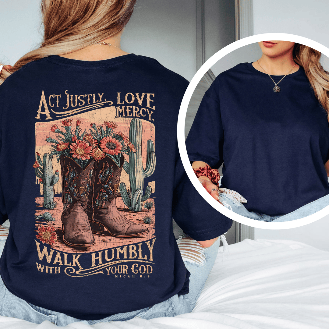 Rear view of a woman wearing Micah 6:8 t-shirt from Black.jpg, featuring western cowboy boots, cacti, and desert wildflowers.
