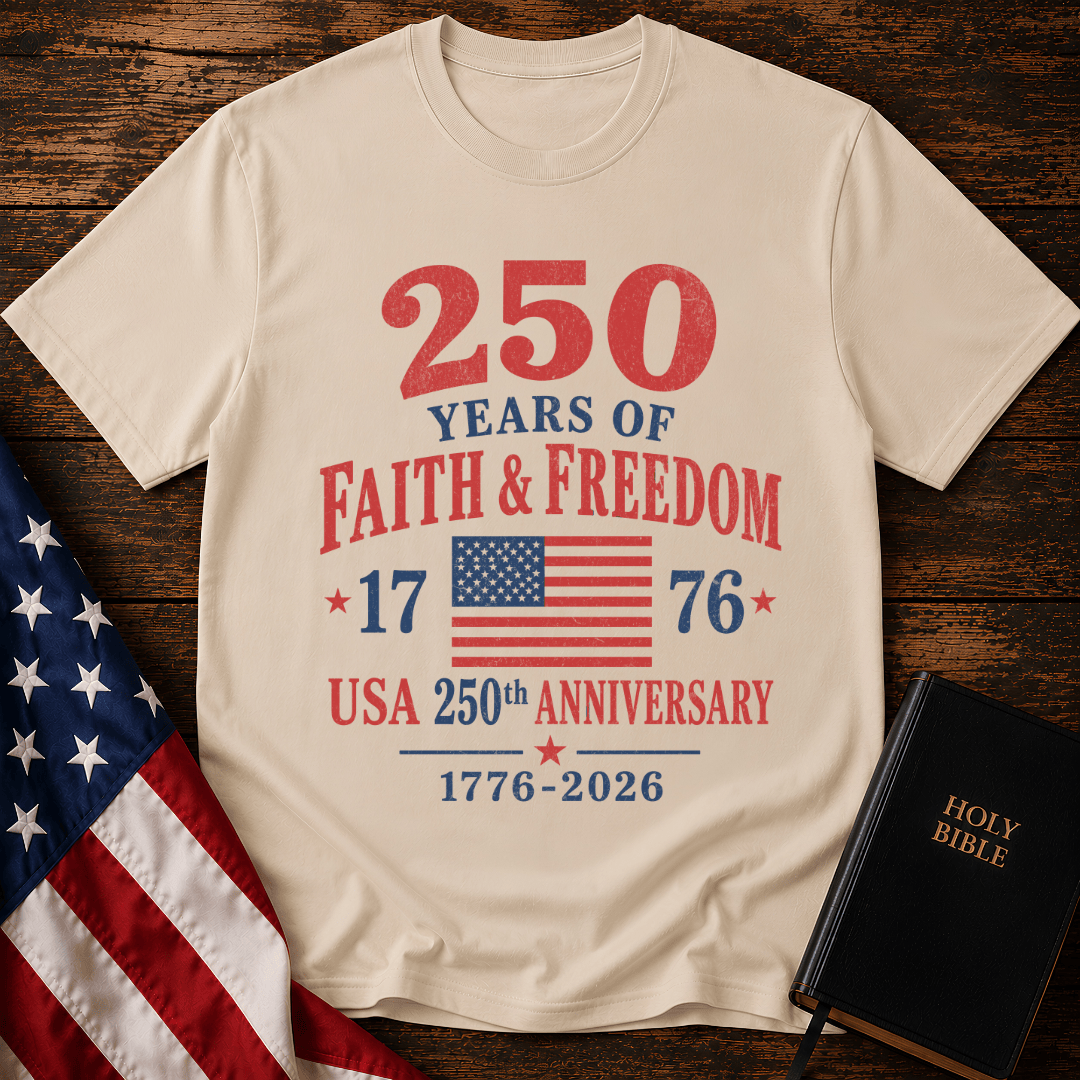 Patriotic t-shirt reading 250 Years of Faith and Freedom 1776 to 2026 with an American flag on a wood 