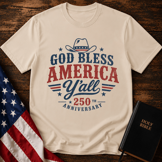 Christian t shirts featuring a Western cowboy hat, USA flag details, and God Bless America Y'all text on wood.