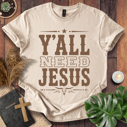 Y'all Need Jesus country western graphic tee with a longhorn skull design next to a Bible and cross.