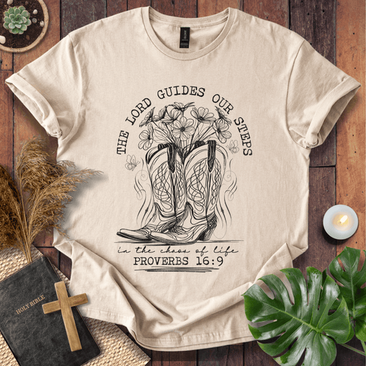 Western cowboy boots with wildflowers and butterflies on shirt with Proverbs 16:9 Bible verse text.