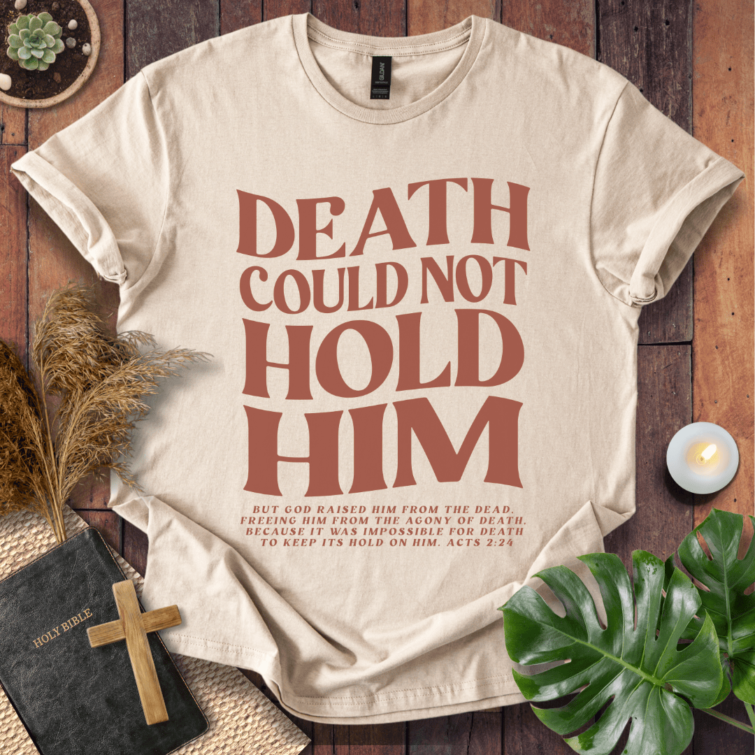 Christian Easter t-shirt with "Death Could Not Hold Him" Acts 2:24 text, styled with a Bible and wooden cross