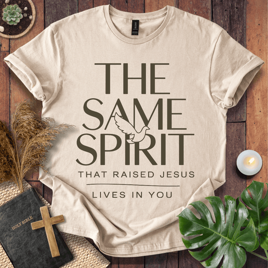 Easter Christian t-shirt with "The Same Spirit That Raised Jesus Lives In You" text and dove icon on wooden background.