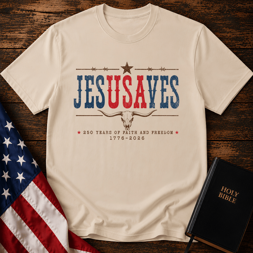 Patriotic sand colored graphic t shirt with Jesus Saves text, a longhorn skull, barbed wire, and American flag.