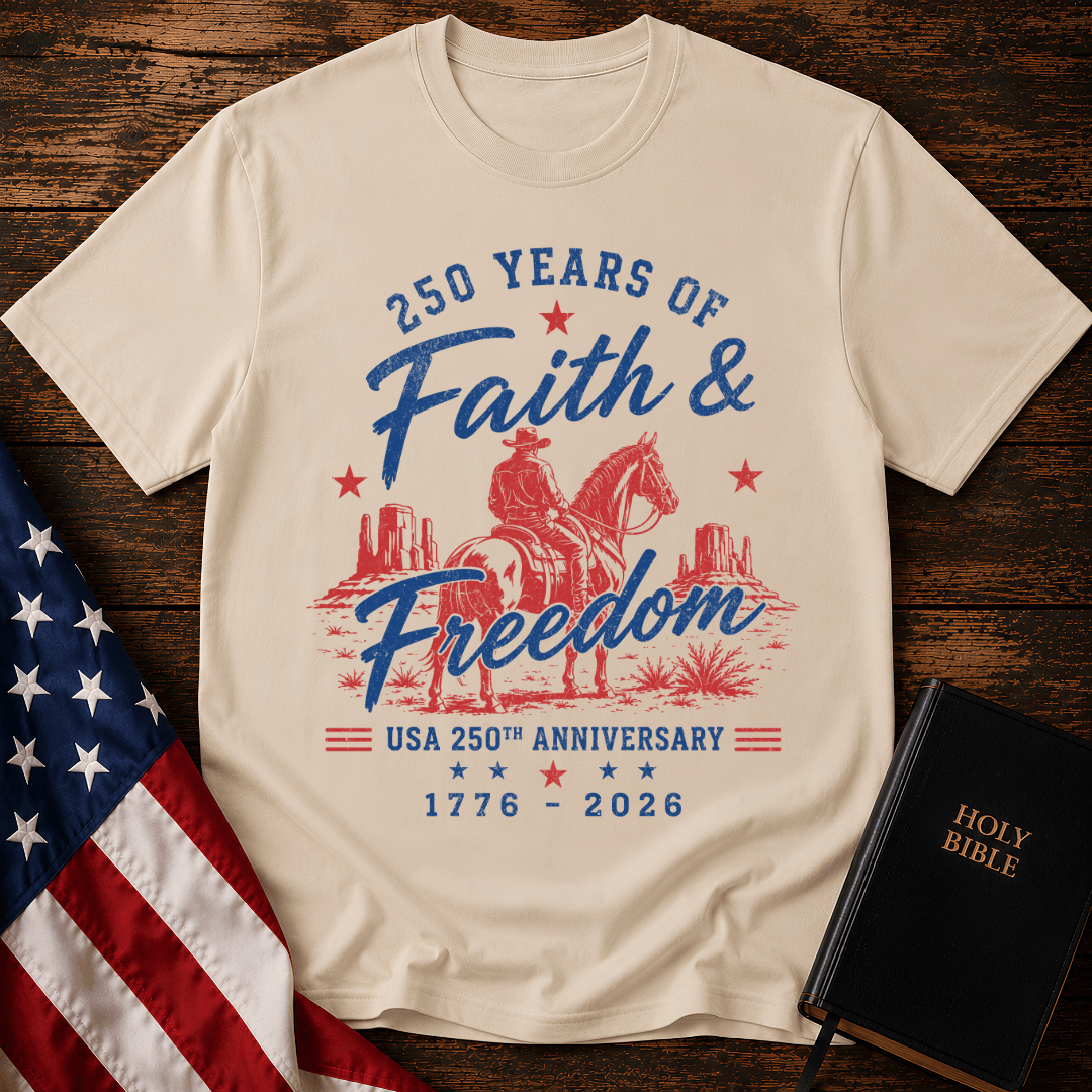 Christian t shirt for women featuring a cowboy on a horse looking at canyon mesas with Faith & Freedom text.