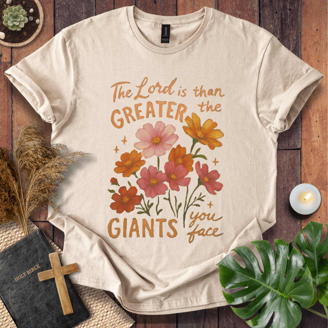 “The Lord is greater than the giants you face” floral lettering Christian t-shirt; uplifting faith tee.