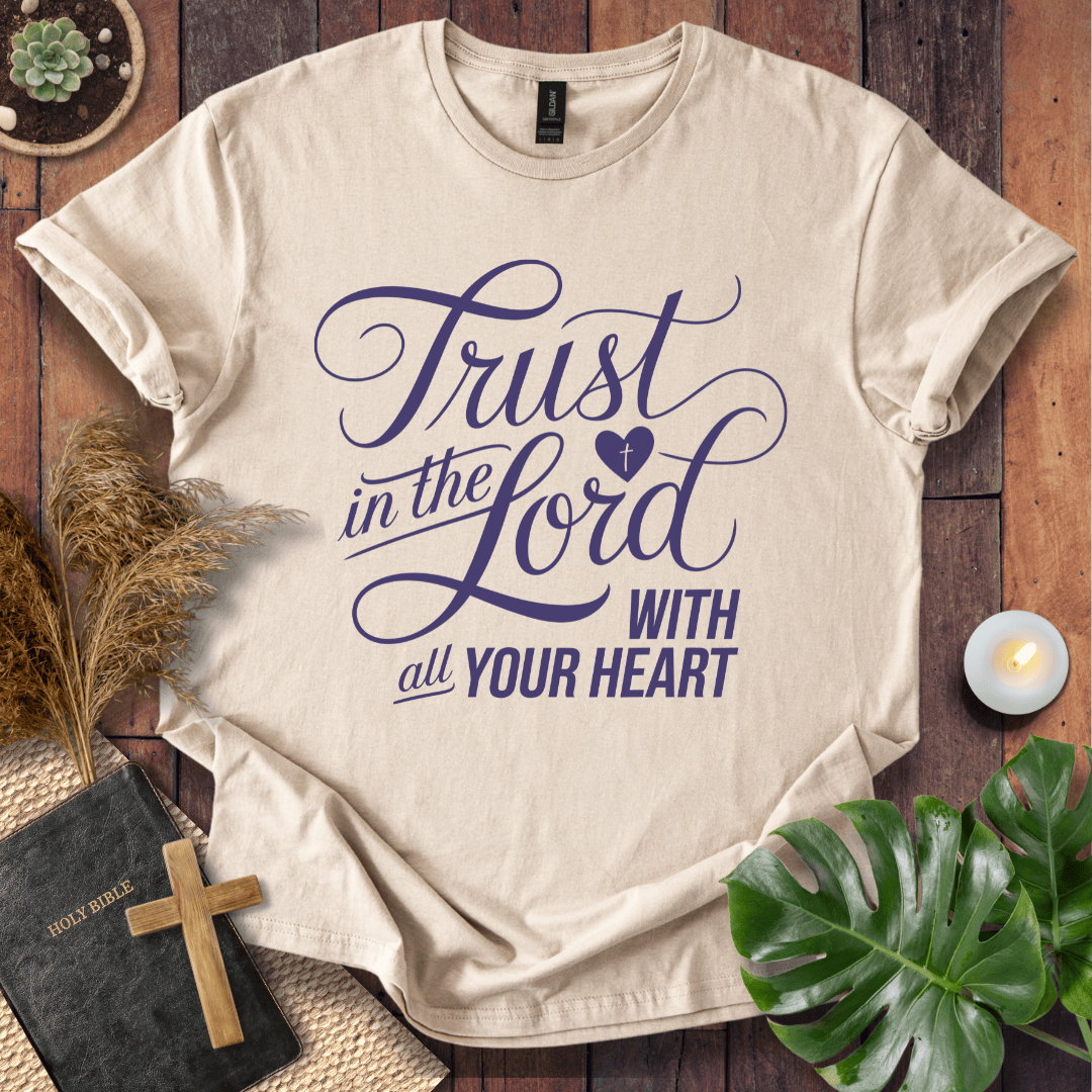 Proverbs 3:5 Trust in the Lord script design on a Christian t shirt for women styled with a bible and cross.
