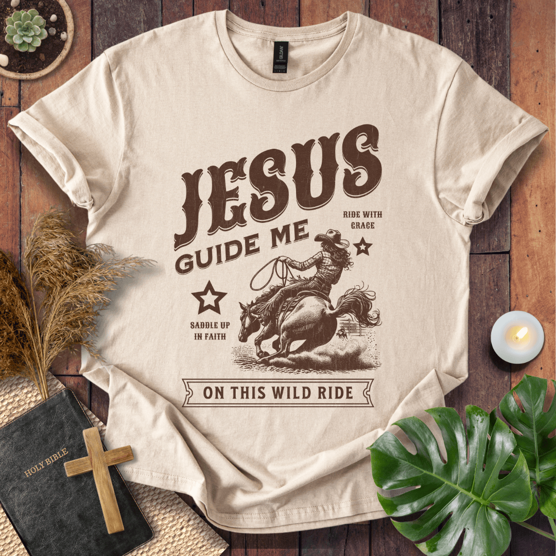 Vintage style t-shirt with a cowgirl riding a horse and text reading Jesus Guide Me On This Wild Ride.