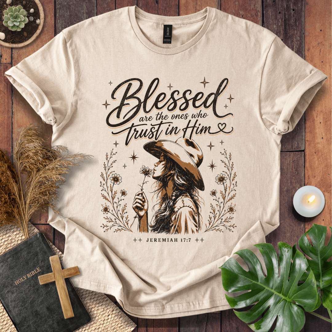 Jeremiah 17:7 sand t-shirt featuring a western woman in a cowboy hat holding a flower with stars and branches.