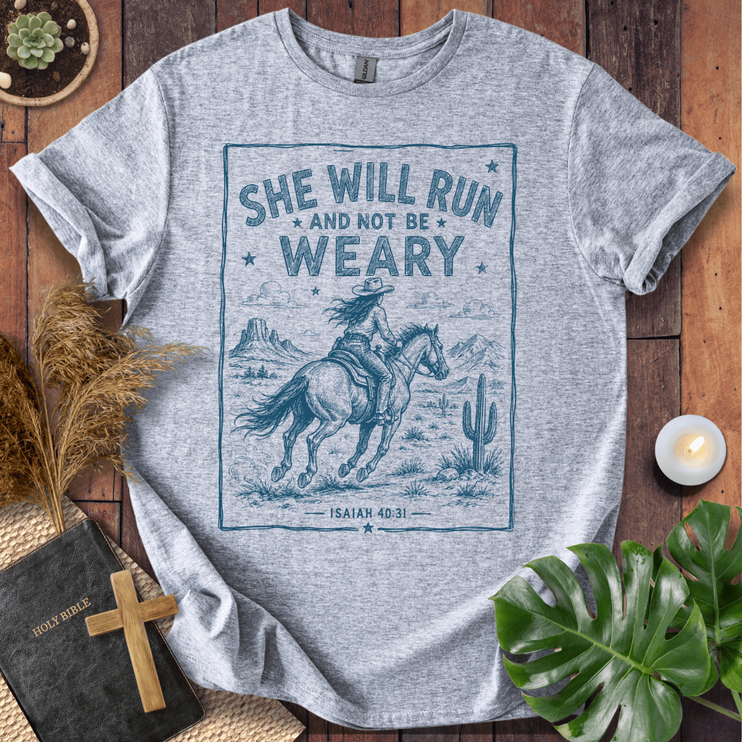 graphic tee with a blue sketch of a cowgirl riding a horse in the desert under Isaiah forty thirty-one text.