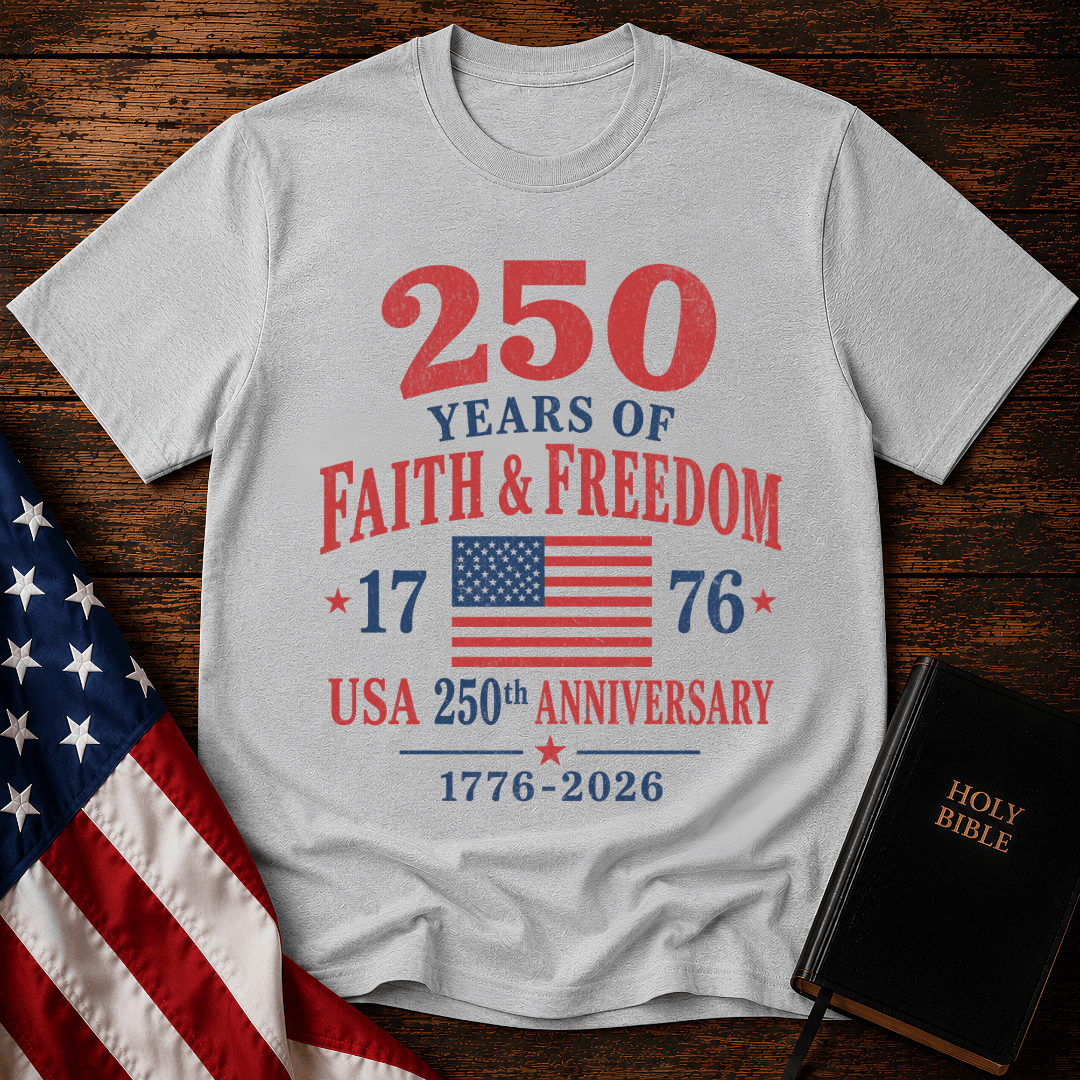 Patriotic t-shirt reading 250 Years of Faith and Freedom 1776 to 2026 with an American flag on a wood 
