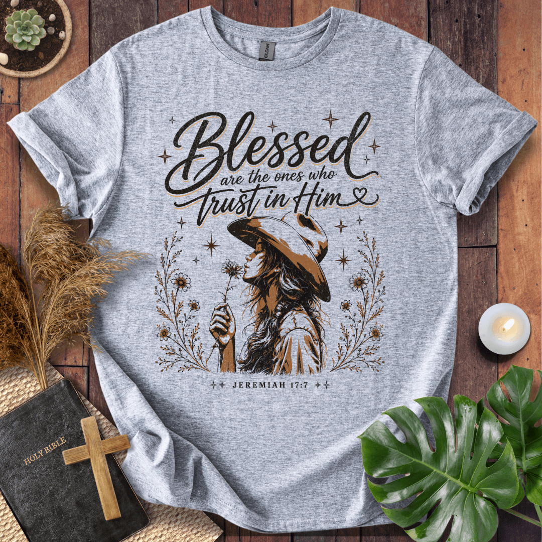Jeremiah 17:7 sand t-shirt featuring a western woman in a cowboy hat holding a flower with stars and branches.