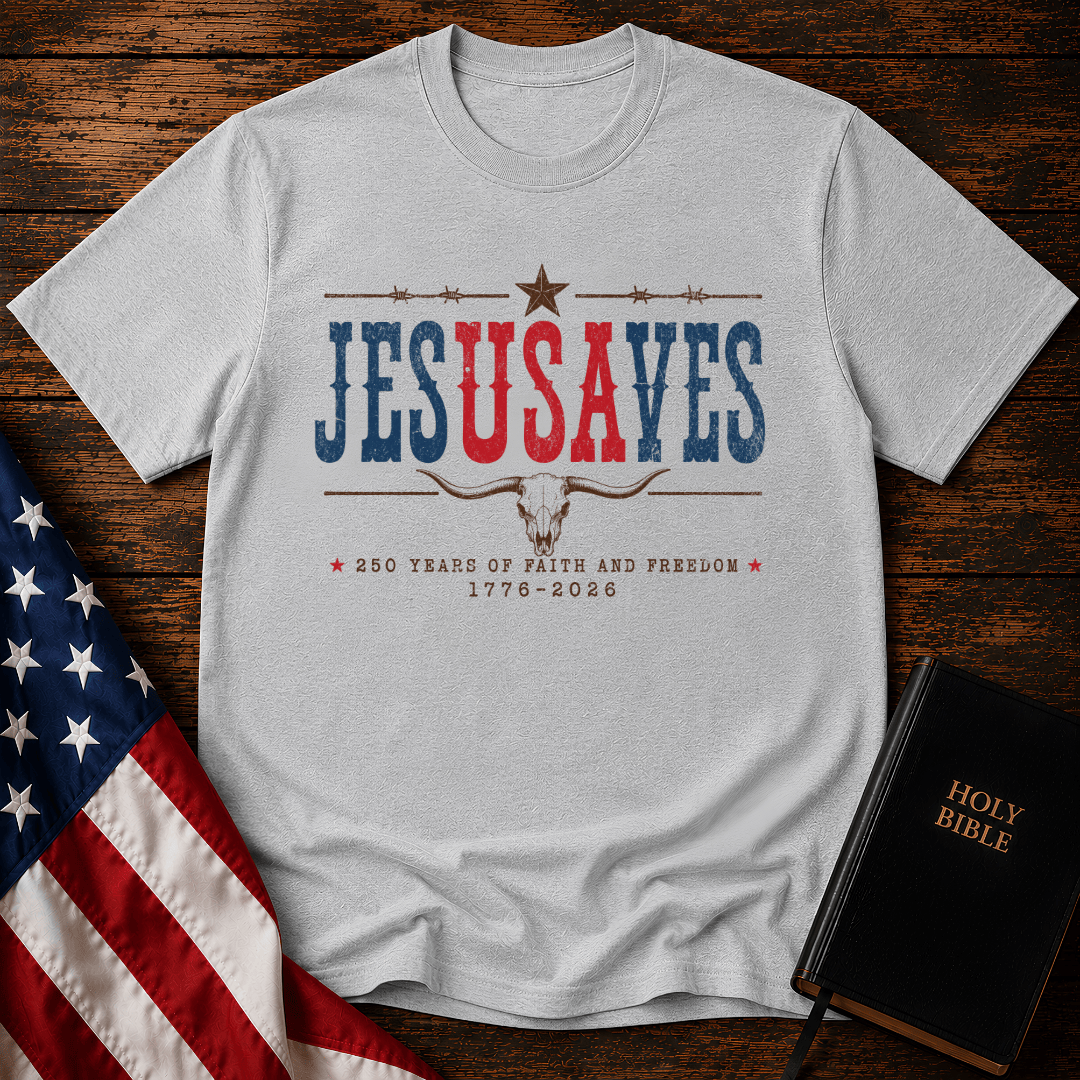 Patriotic sand colored graphic t shirt with Jesus Saves text, a longhorn skull, barbed wire, and American flag.