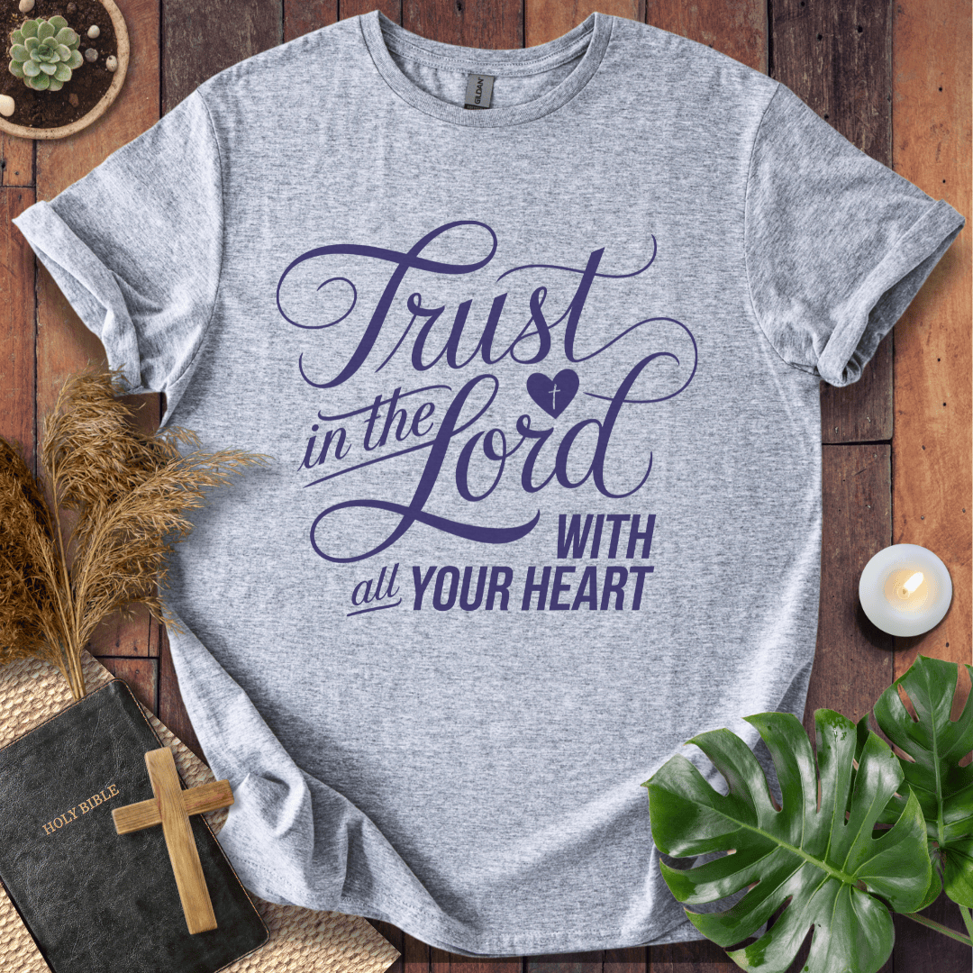 Proverbs 3:5 Trust in the Lord script design on a Christian t shirt for women styled with a bible and cross.