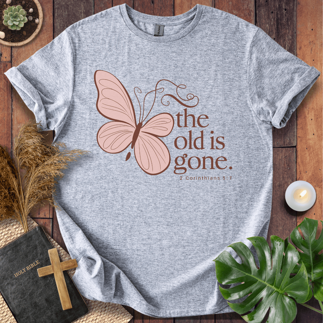 t-shirt with a dusty rose butterfly and "the old is gone" 2 Corinthians 5:17 text in brown ink.