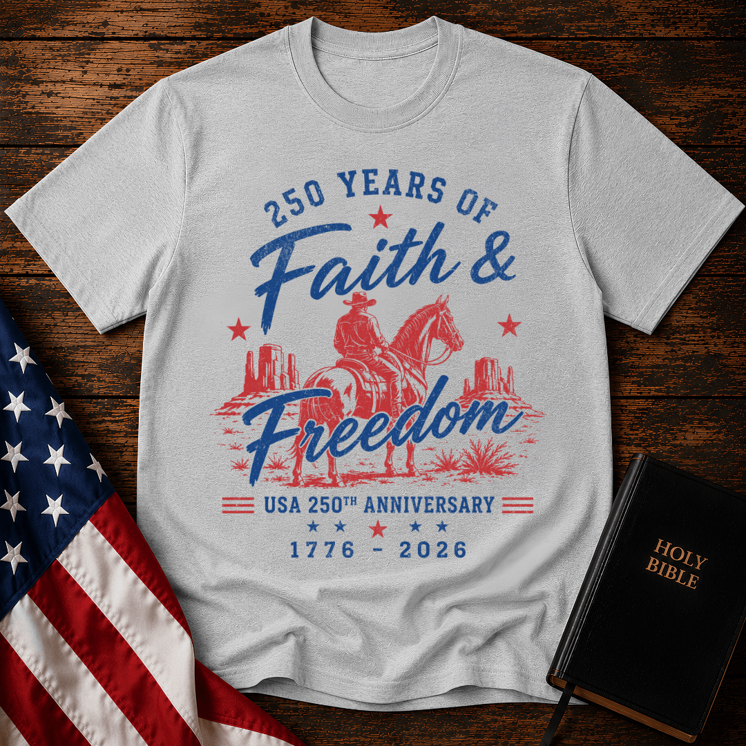 Christian t shirt for women featuring a cowboy on a horse looking at canyon mesas with Faith & Freedom text.