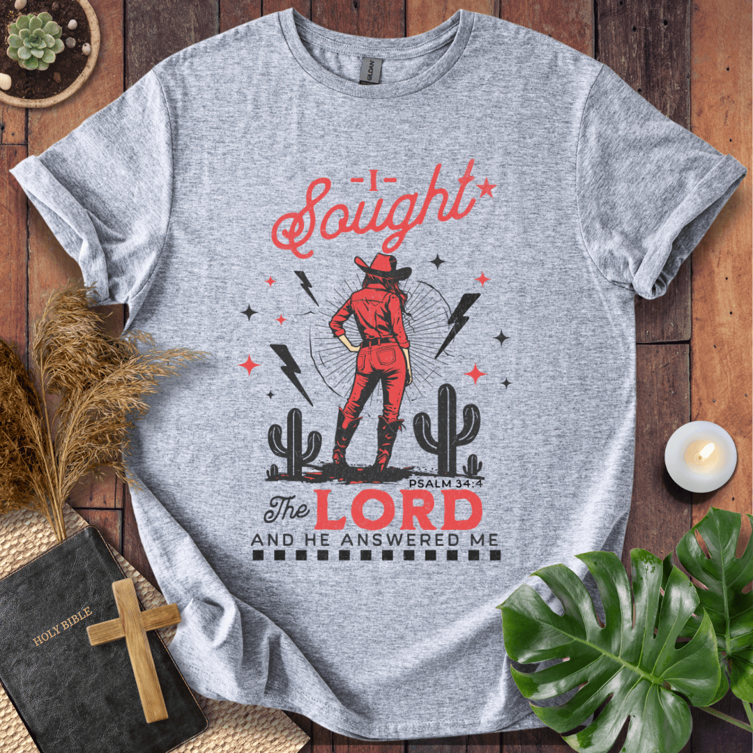 Cowgirl in red standing in a desert with cacti and lightning, text reads I Sought The Lord And He Answered Me Psalm 34:4.