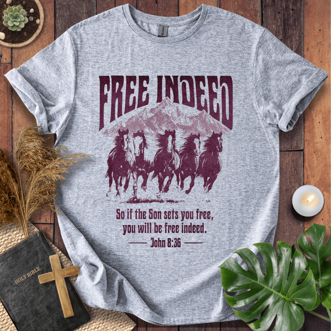 t-shirt featuring five wild horses, mountains, and John 8:36 "Free Indeed" in a vintage distressed print.