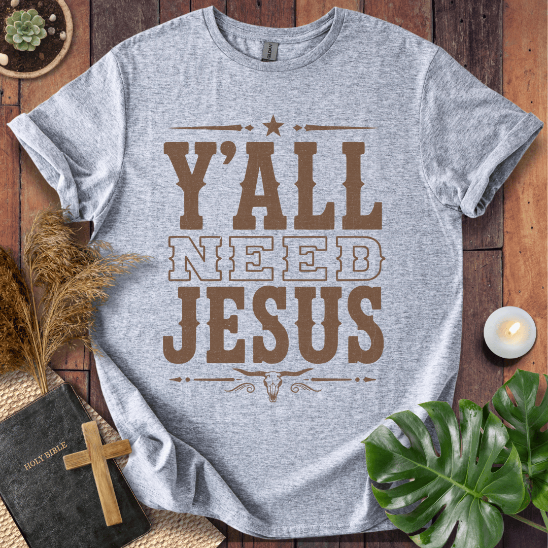 Y'all Need Jesus country western graphic tee with a longhorn skull design next to a Bible and cross.